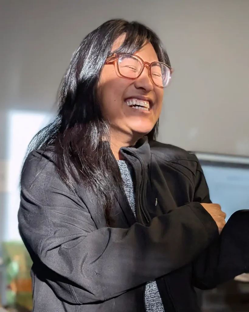 Portrait of Mel Camacho, Bookkeeper at Meals on Wheels of the Monterey Peninsula, smiling in natural light.