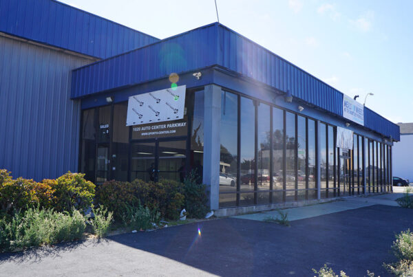 Exterior of the purchased building for the second Meals on Wheels of the Monterey Peninsula kitchen with a temporary Meals on Wheels sign.